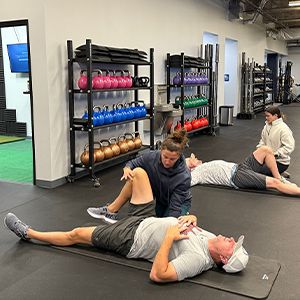 Two coaches performing a golf movement assessment