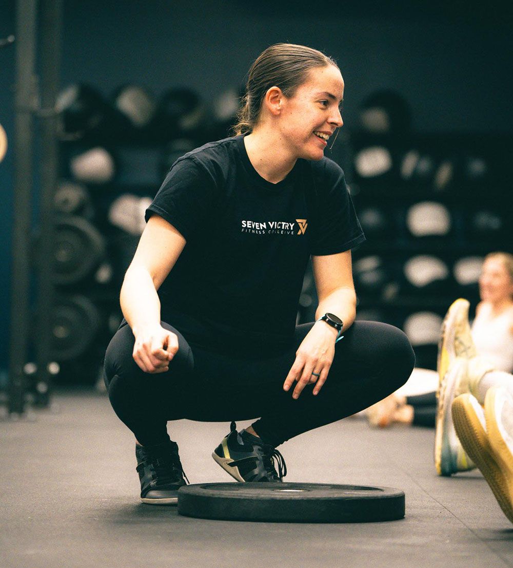 Trainer helping client