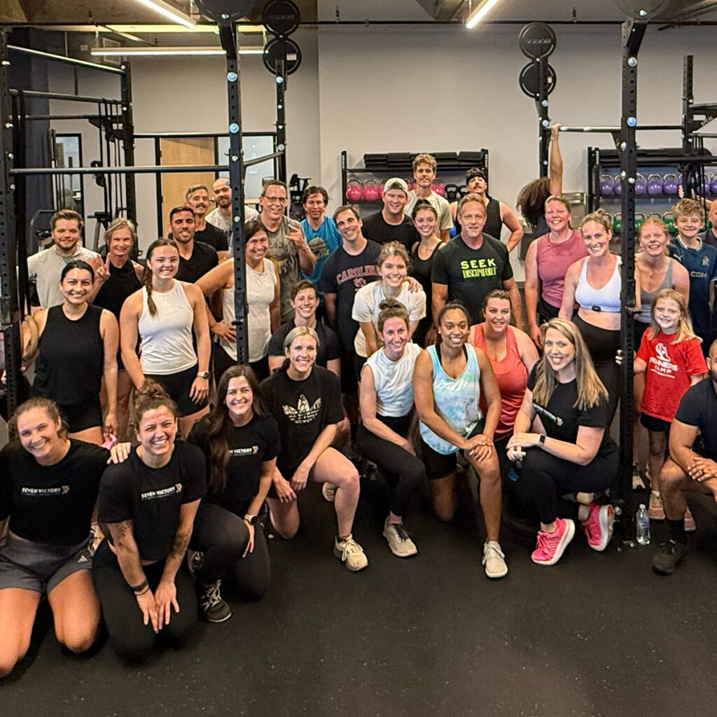 Group fitness class standing together in gym